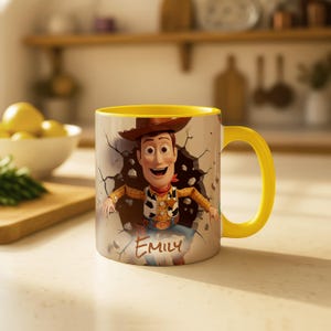 May include: A ceramic mug with a yellow handle and interior. The mug features a graphic of the character Woody from Toy Story breaking through a wall. The name "Emily" is written on the mug.