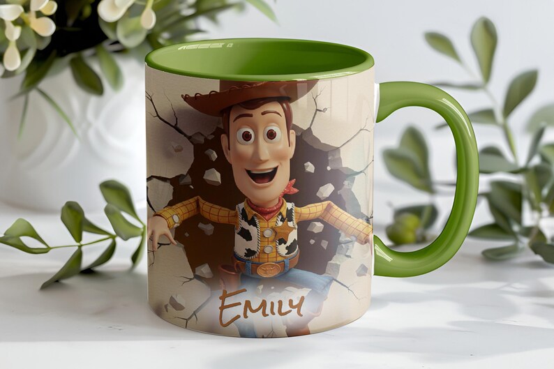 May include: A ceramic mug featuring a cartoon image of Woody from Toy Story breaking through a wall. The mug has a green handle and interior, with the name "Emily" printed on the front.