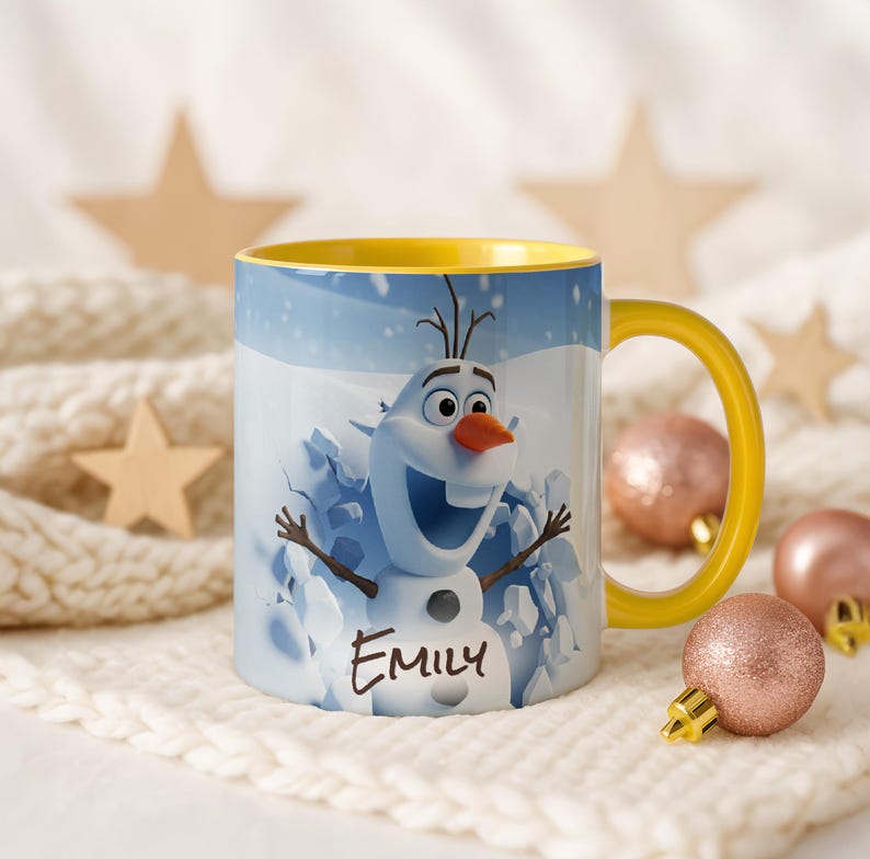 May include: A white ceramic mug with a yellow handle and interior. The mug features a cartoon image of Olaf from Frozen, with the name "Emily" printed below. The background shows a snowy scene.