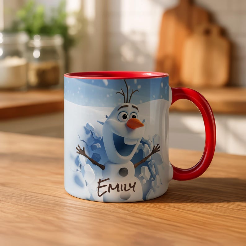 May include: White ceramic mug with a red handle and interior rim. The mug features a cartoon image of Olaf from Frozen, with the name "Emily" printed below. The background shows a snowy scene.
