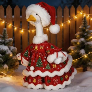 May include: A white goose figurine wearing a red velvet dress with a white faux fur trim and a matching Santa hat. The dress features a repeating pattern of green Christmas trees, yellow bells, and red bows. The goose has a yellow beak and eyes.