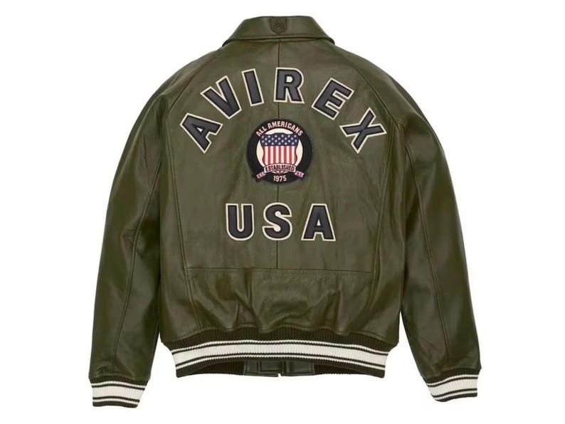 May include: Olive green leather jacket with the word "AVIREX" arched across the back, above a patch with the American flag and the words "ALL AMERICANS ESTABLISHED 1975". The word "USA" is below the patch. The jacket has white and black striped cuffs and hem.