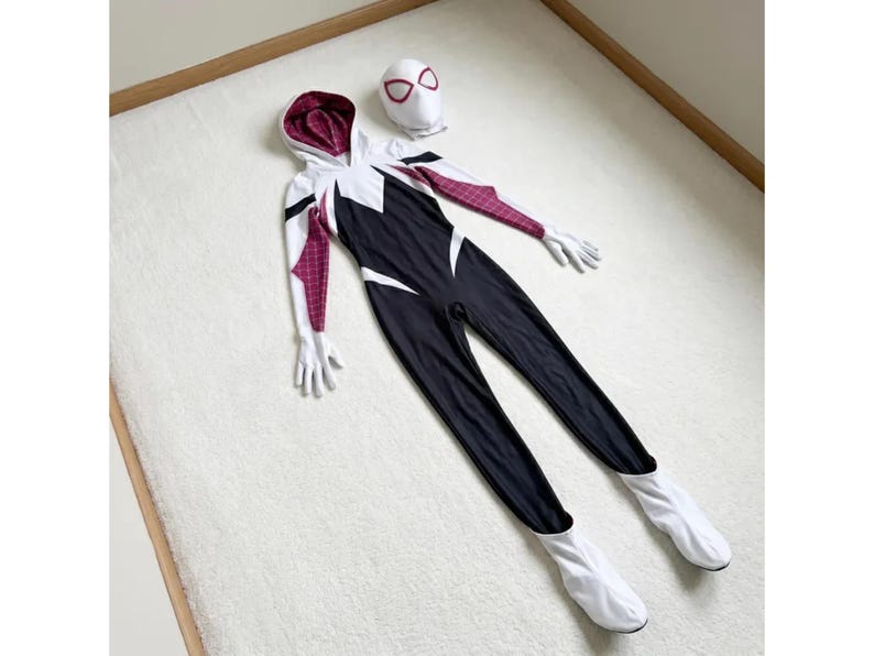 May include: A black, white, and maroon Spider-Gwen costume set. The set includes a hooded jumpsuit, gloves, and a mask. The jumpsuit is primarily black with white accents and maroon patterned sleeves.