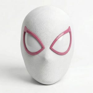 May include: A white mask with pink eye frames, resembling a superhero's mask. The mask has a textured surface and a pointed chin. The eye openings are white.