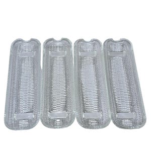 May include: Set of four clear glass corn on the cob serving dishes. The dishes are designed to hold corn on the cob and have a textured surface that resembles corn kernels.