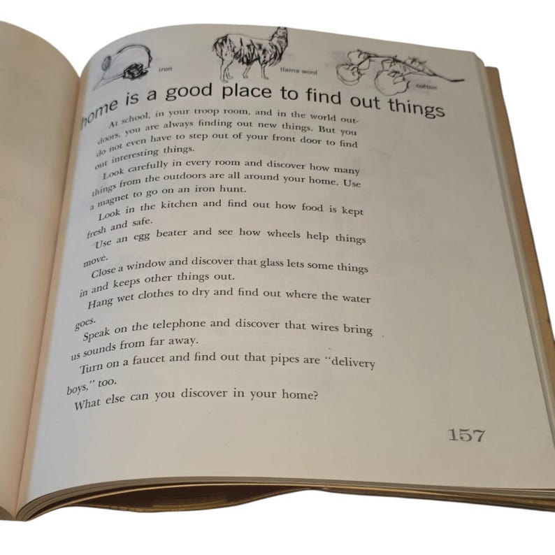 May include: Open book with text: "home is a good place to find out things." The page has illustrations of an iron, a llama, and other objects. The text encourages exploration and discovery within the home.