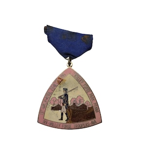 May include: A white ceramic mug with a black handle and the text "But First, Coffee" in a black, bold font. The mug is sitting on a wooden surface. The mug is approximately 4 inches tall.