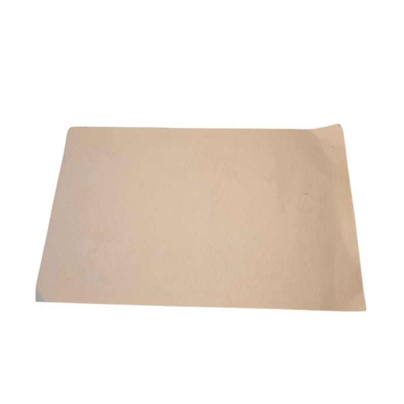 May include: A rectangular sheet of light tan paper with a slightly curved edge. The paper has a smooth surface and appears to be blank. The sheet is positioned horizontally against a white background.
