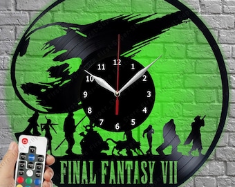 May include: A circular wall clock crafted from a black vinyl record featuring a green backlit design of the Final Fantasy VII logo and character silhouettes. The clock face is black with white numbers and includes a remote control for lighting.