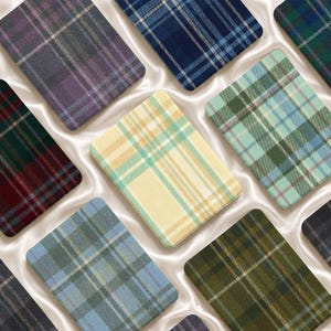 May include: A collection of rectangular fabric swatches featuring various plaid and tartan patterns in diverse color palettes including yellow, blue, green, purple, and burgundy, arranged in a grid-like layout with rounded corners.