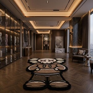 May include: A large, brown, beige, and black area rug shaped like a cartoon character with X-shaped eyes, positioned on a dark wood herringbone floor in a room featuring glass display cabinets filled with figurines and modern furniture.