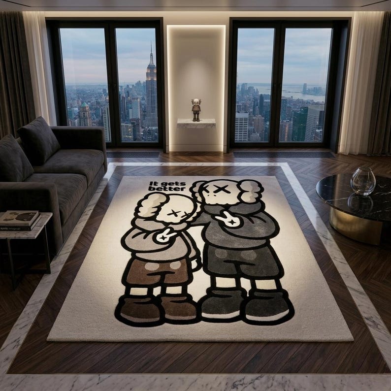 May include: A rectangular area rug featuring a graphic illustration of two cartoon characters with X-shaped eyes, wearing hoodies and shorts, making peace signs. The text "It gets better" is printed in black above the figures on a cream background.