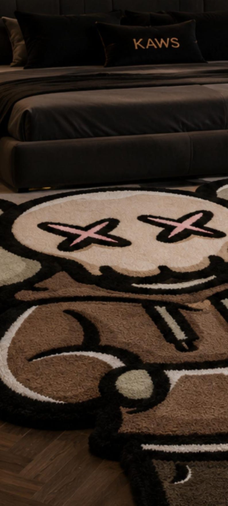 May include: A plush area rug featuring a stylized character design with a tan face, black outlines, and pink cross-shaped eyes. The rug incorporates brown, white, and light green color blocks in a cartoon-inspired graphic pattern with a soft texture.