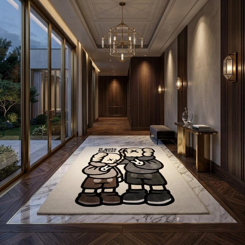 May include: A rectangular area rug featuring a cream-colored background with a large graphic illustration of two cartoon characters in shades of brown, gray, and black. The text "It gets better" is printed in black above the characters.