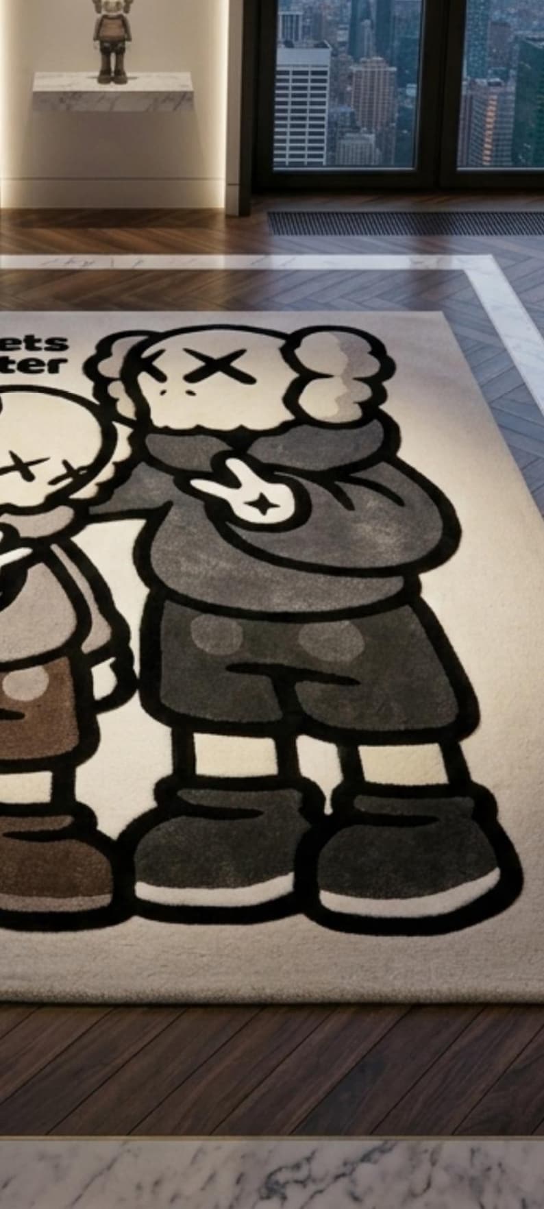 May include: A rectangular area rug featuring a large graphic illustration of two cartoon characters with X-shaped eyes. The characters are rendered in shades of gray, brown, and black on a light beige background. The text ets ter is visible.