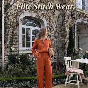 May include: An orange linen two-piece outfit, including a button-down shirt and wide-leg pants. The outfit is worn with sandals and a woven clutch. The text "Elite Stitch Wear" is displayed at the top of the image.
