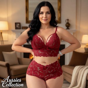 May include: A deep red lace lingerie set, including a bralette with delicate straps and a high-waisted bottom. The set features a floral pattern and is from the Aussies Collection. The background includes a fireplace, chairs, and a mirror.