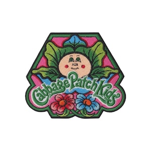May include: Embroidered patch featuring a Cabbage Patch Kids design. The patch has a green border and a pink background. The design includes a cartoon face, green leaves, and the words "Cabbage Patch Kids" in green and white.