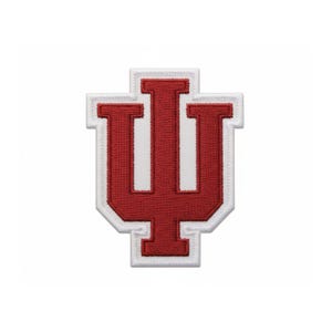 May include: Embroidered patch featuring the Indiana University logo, a stylized crimson letter "I" over a "U" shape. The patch has a white border and is designed for application on clothing or accessories.