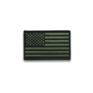 May include: A rectangular patch featuring the American flag in shades of green and black. The stars are in the upper left corner, and the stripes run horizontally across the patch. The patch has a black border.