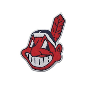 May include: Embroidered patch featuring a cartoon-style Native American head with a red face, white teeth, and a feather. The design includes navy blue and white accents, with a white border.