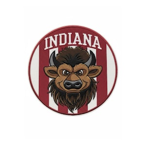 May include: Embroidered patch featuring a cartoon bison head with a stern expression. The bison is brown with black horns and a dark mane. The patch has a red and white striped background with the word "INDIANA" in white block letters.