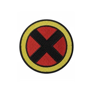 May include: Embroidered patch featuring a red circle with a black "X" inside, surrounded by a yellow border. The patch is circular and has a stitched appearance, suitable for application on clothing or accessories.