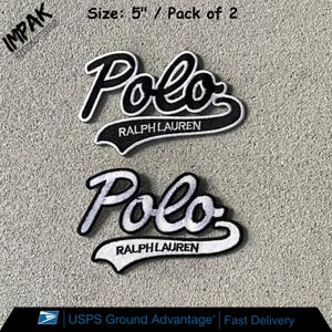 May include: Two embroidered patches featuring the "Polo Ralph Lauren" logo in black and white. Each patch is approximately 5 inches in size. The patches have a classic script font and are designed for apparel or accessories.