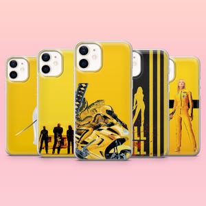 May include: A collection of yellow phone cases featuring movie-themed designs. The cases showcase images of a motorcycle, a woman in a yellow jumpsuit, and silhouettes of characters. The cases have a glossy finish and a pink background.