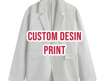 May include: A solid white blazer featuring long sleeves, a notched lapel collar, and two front flap pockets. The center of the garment displays the red text CUSTOM DESIN PRINT in a bold, sans-serif font with a white outline for high visibility.
