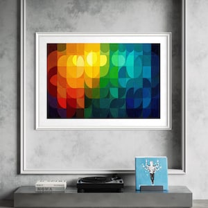 May include: A framed abstract art print with a vibrant, colorful design. The artwork features a geometric pattern of overlapping shapes in a spectrum of colors, including red, orange, yellow, green, and blue. A record player and books are on a shelf below.