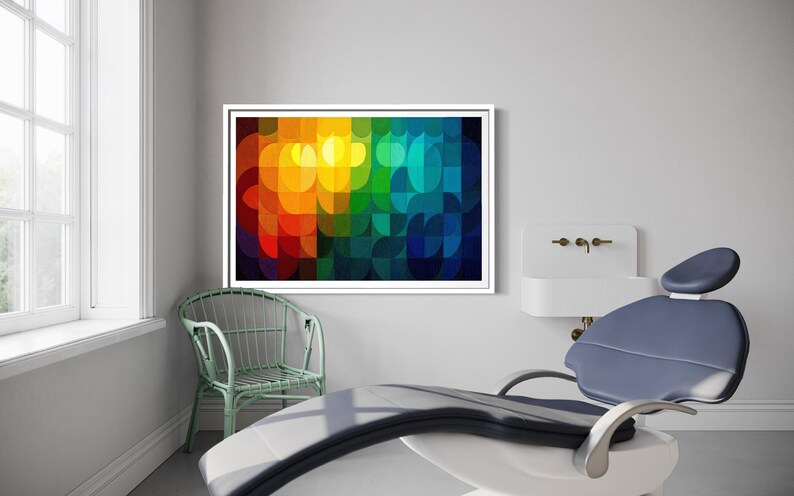 May include: A framed abstract art piece with a vibrant, colorful design dominates the room. The artwork features a pattern of overlapping, rounded shapes in shades of red, orange, yellow, green, and blue. A dental chair and a small green chair are also in the room.