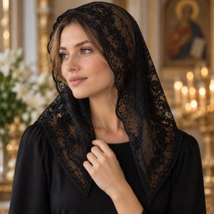 May include: A black lace chapel veil featuring an intricate floral pattern with a scalloped edge. The triangular head covering is crafted from sheer, lightweight fabric and is worn draped over the head, framing the face with delicate embroidery.