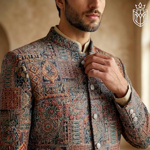 May include: A patterned jacket with a mandarin collar. The jacket features a detailed design in shades of blue, red, and brown. The jacket has silver buttons and is part of a formal wear collection.
