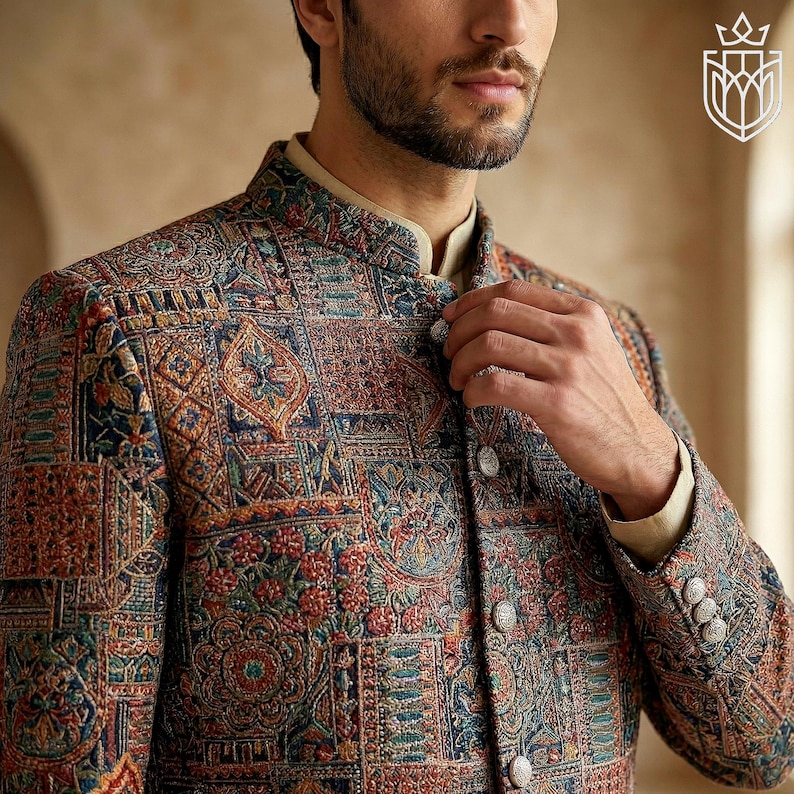 May include: A patterned jacket with a mandarin collar. The jacket features a detailed design in shades of blue, red, and brown. The jacket has silver buttons and is part of a formal wear collection.