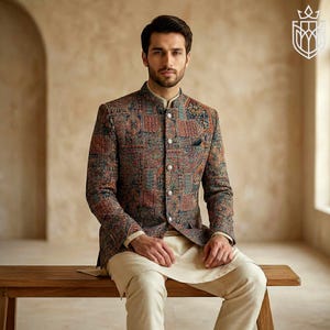 May include: A patterned jacket with a mandarin collar, featuring a mix of colors including red, blue, and brown. The jacket is paired with cream-colored pants and a matching shirt. The outfit is suitable for formal occasions.