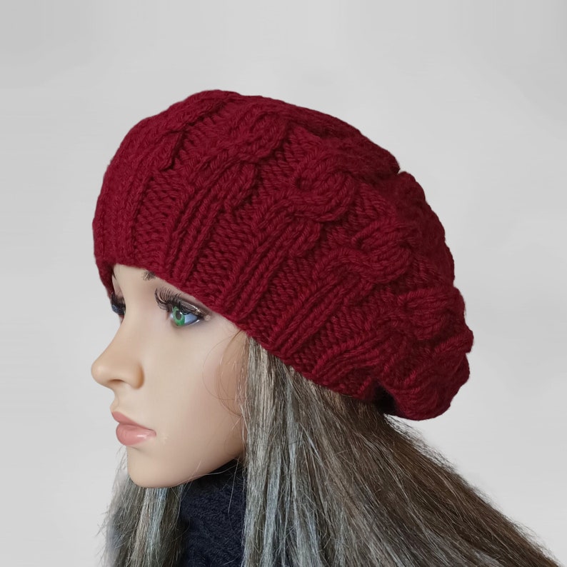 a mannequin head wearing a red knitted hat