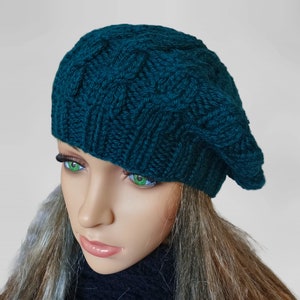 a mannequin head wearing a green knitted hat