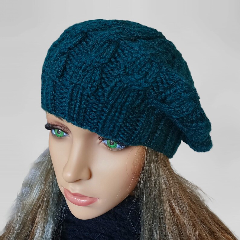 a mannequin head wearing a green knitted hat