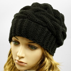 a mannequin head wearing a black knitted hat