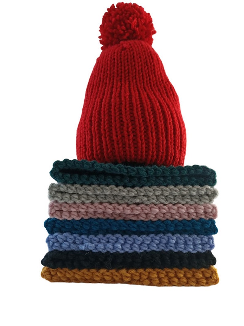 a stack of knitted hats sitting on top of a table