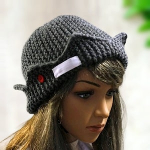 a close up of a mannequin head wearing a knitted hat