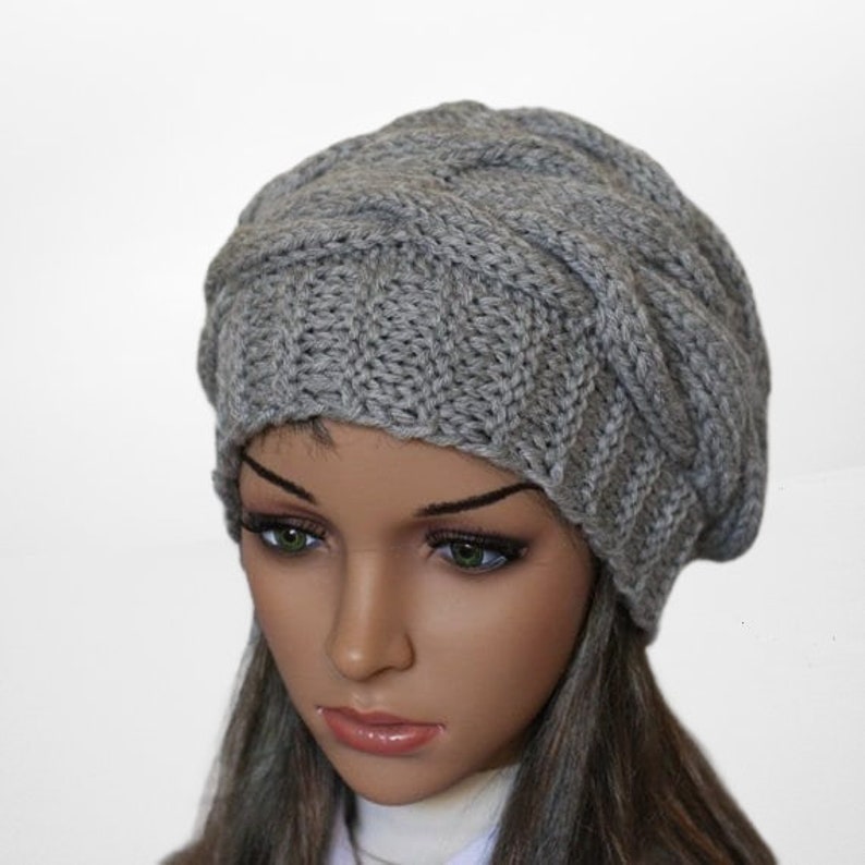 a mannequin head wearing a gray knitted hat