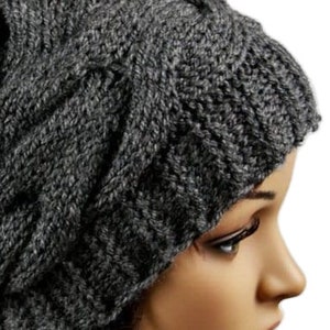 a close up of a mannequin's head wearing a knitted hat