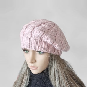 a mannequin head wearing a pink knitted hat