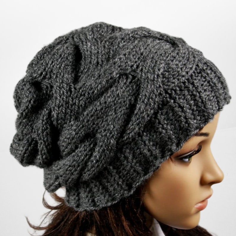 a mannequin head wearing a gray knitted hat