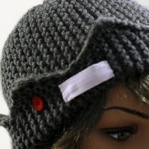 a close up of a mannequin's head wearing a knitted hat