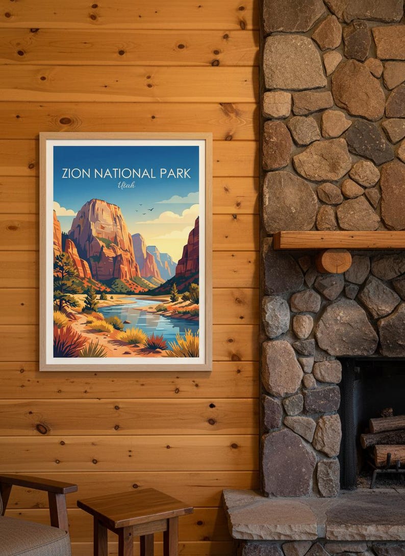 May include: Framed art print of Zion National Park in Utah. The artwork depicts a scenic landscape with towering red rock formations, a river, and a blue sky. The print is in a wooden frame and hangs on a wood-paneled wall.