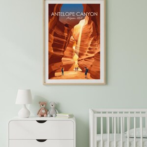 May include: Framed art print of Antelope Canyon in Arizona, USA. The artwork depicts the canyon's sandstone walls in shades of orange and brown, with figures of people at the bottom. The print is in a light wood frame.