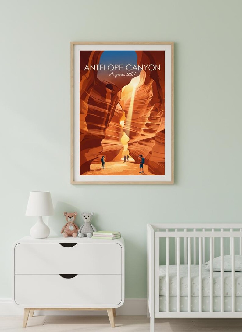 May include: Framed art print of Antelope Canyon in Arizona, USA. The artwork depicts the canyon's sandstone walls in shades of orange and brown, with figures of people at the bottom. The print is in a light wood frame.